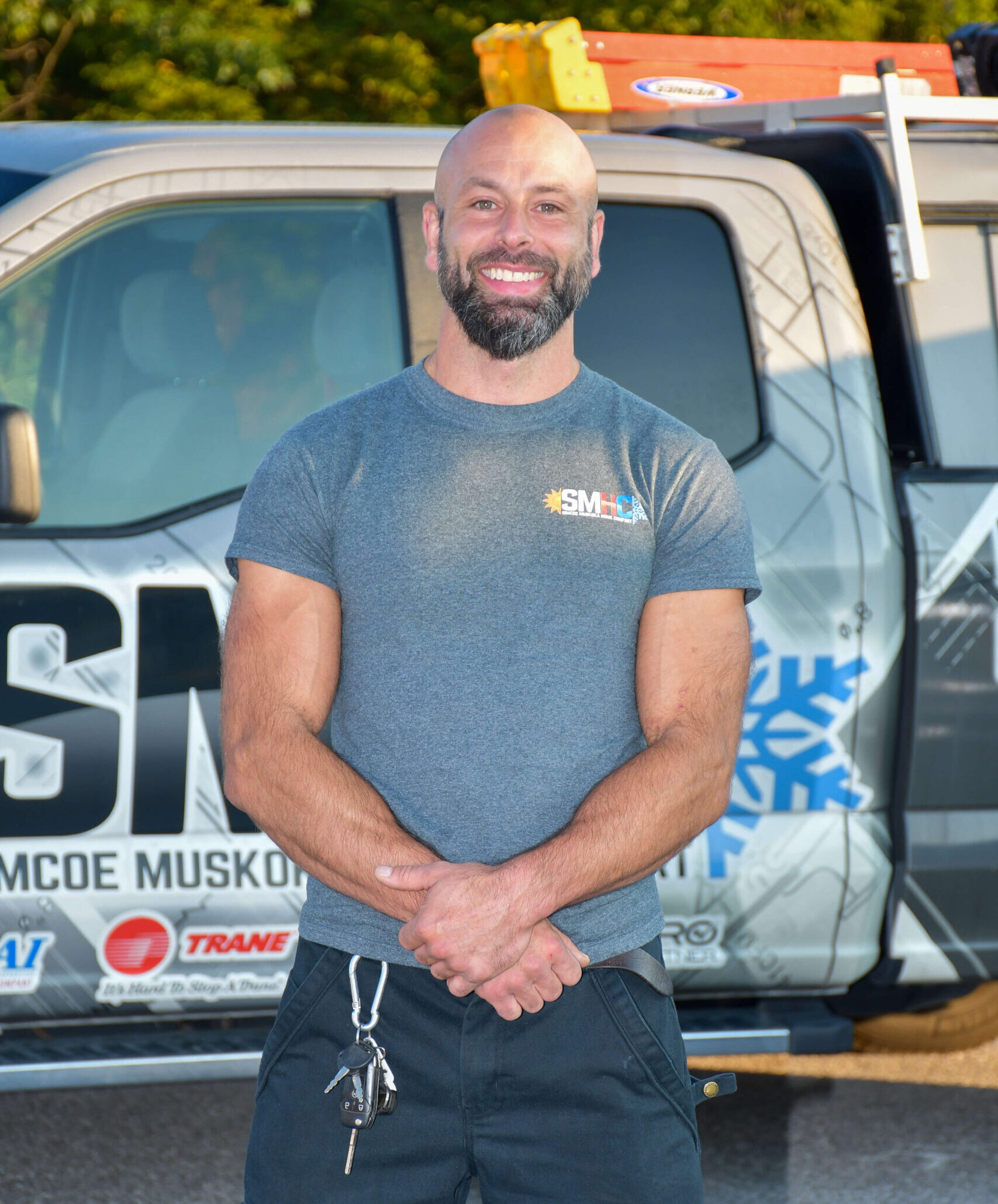 male team member in front of fleet vehicle